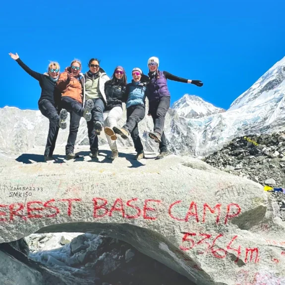 Everest base camp trekking nepal and trekkers celebrating the moment at everest base camp with everest himalayan panorama around