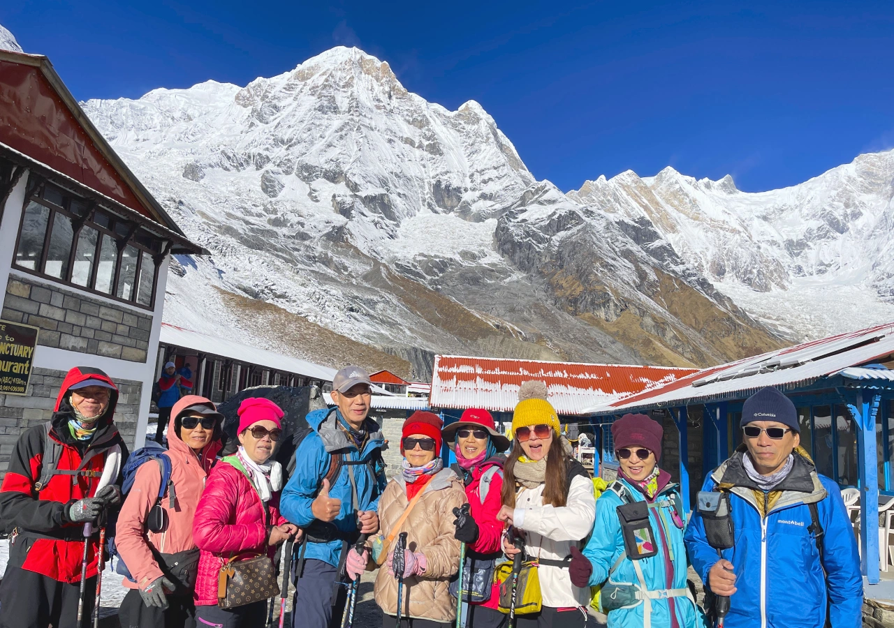 Annapurna Base Camp Trek Trekkers taking group photo with Annapurna Himalayas