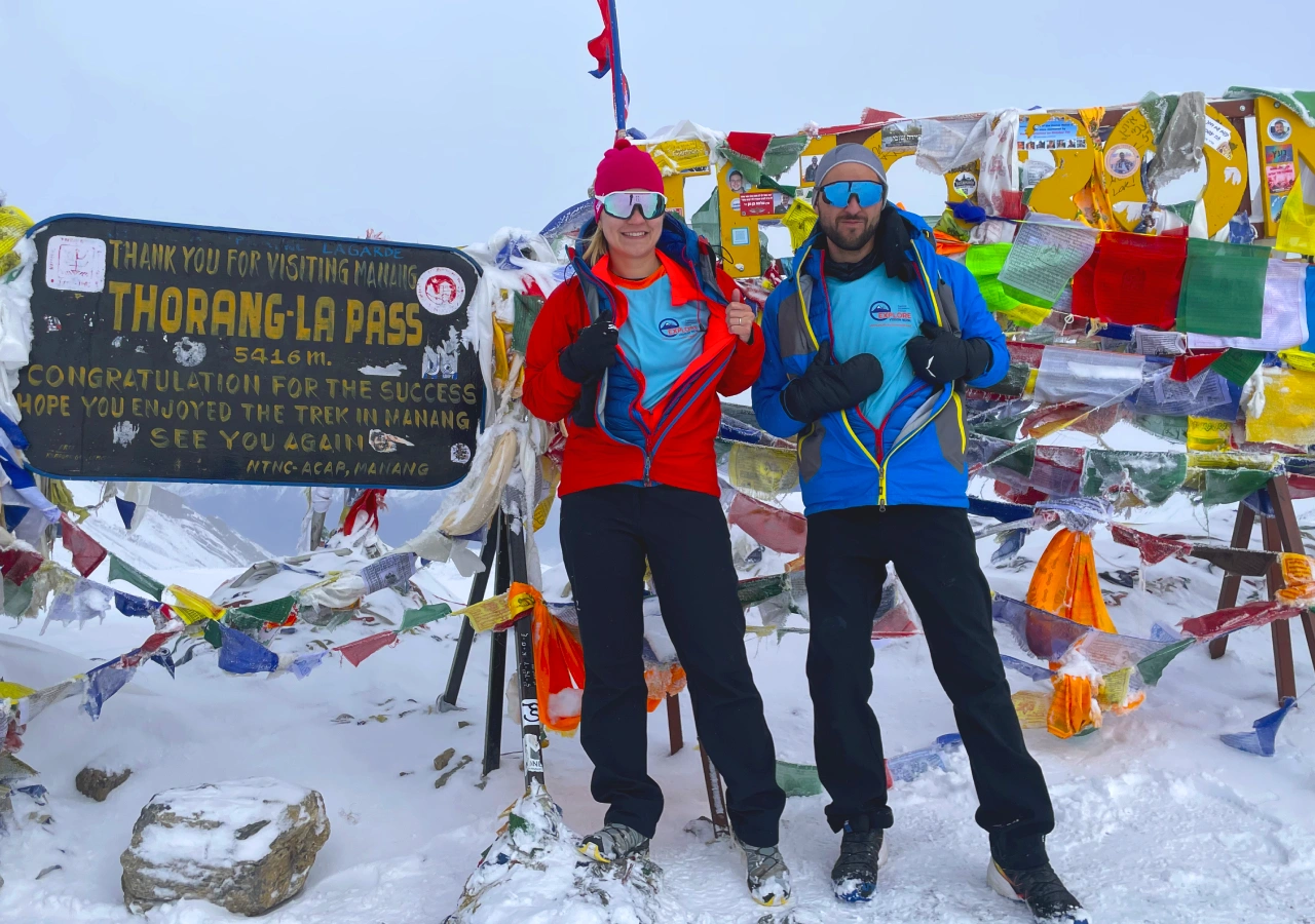 Trekkers celebrating at Thorang La Pass during Annapurna Circuit Trek