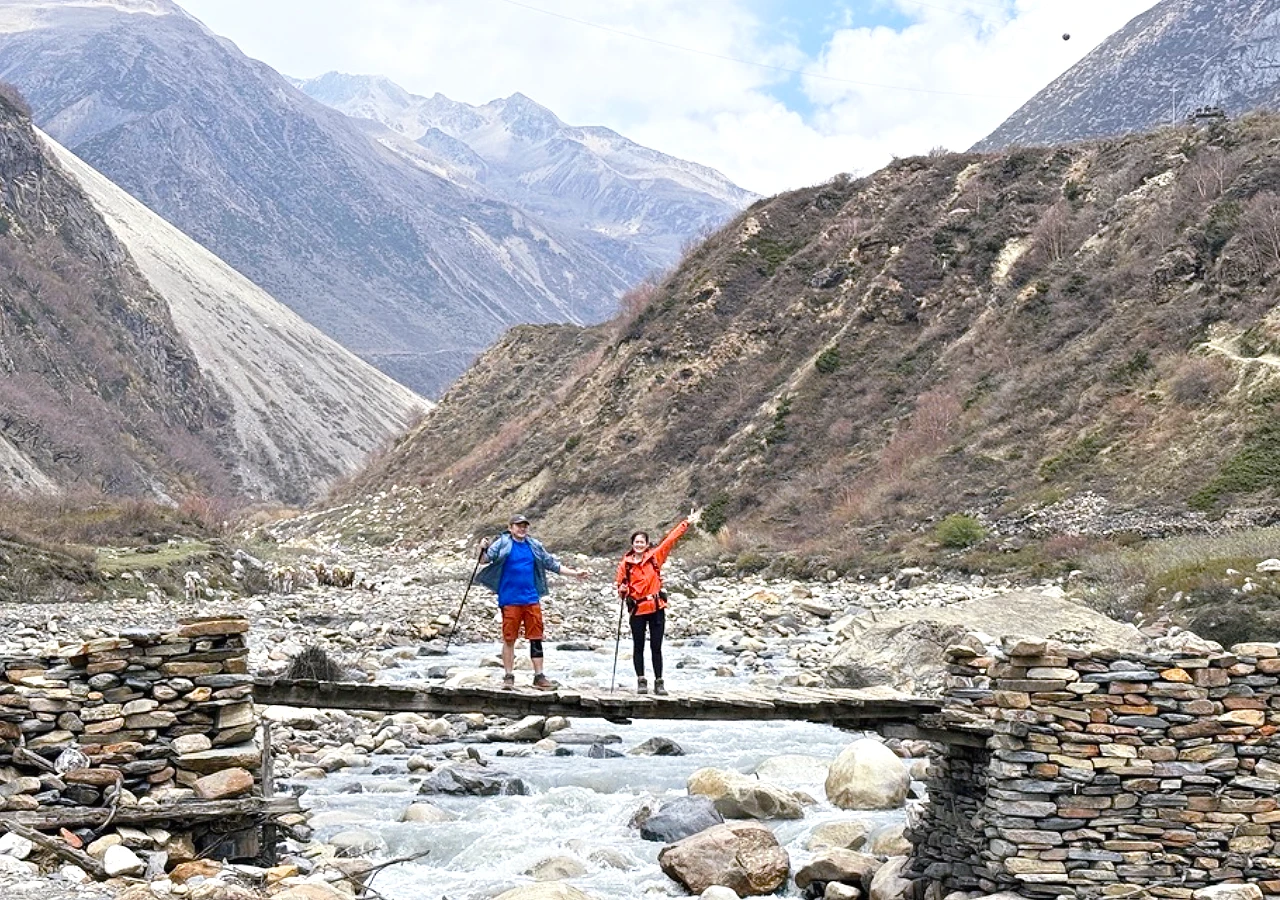 Trekkers Crossing Wood Bridge in Manaslu Circuit with Tsum Valley Trekking Nepal