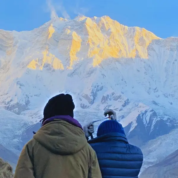 Annapurna Base Camp Trek and trekkers enjoying the golden sunrise from the Annapurna base camp