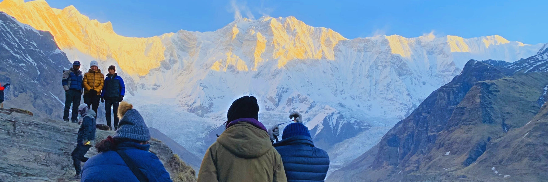 Annapurna Base Camp Trek and trekkers enjoying the golden sunrise from the Annapurna base camp