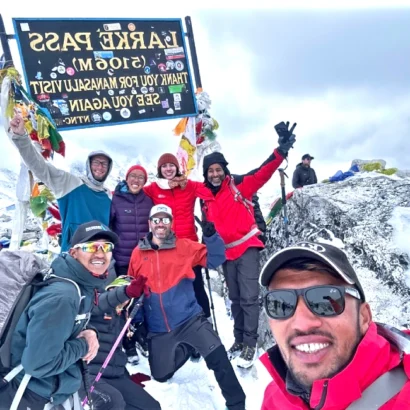 Manaslu trekking trail with larke la pass (5106 m) and trekkers having celebration on the top
