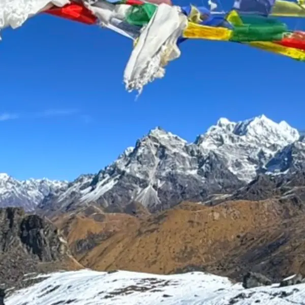 A dramatic view of kanchenjunga himalayan range covered with colorful prayer flags along the kanchenjunga circuit trekking trail