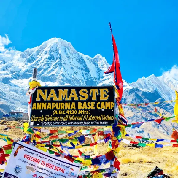 Annapurna base camp's welcome signboard and Himalayas around on short Annapurna base camp trek