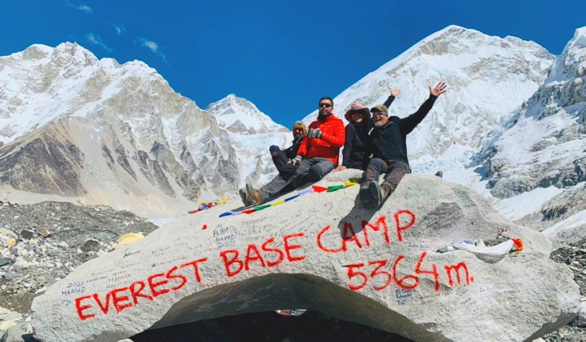 Everest Base Camp height in Nepal at 5,364 meters above sea level and trekkers enjoying the achievement that being at EBC 