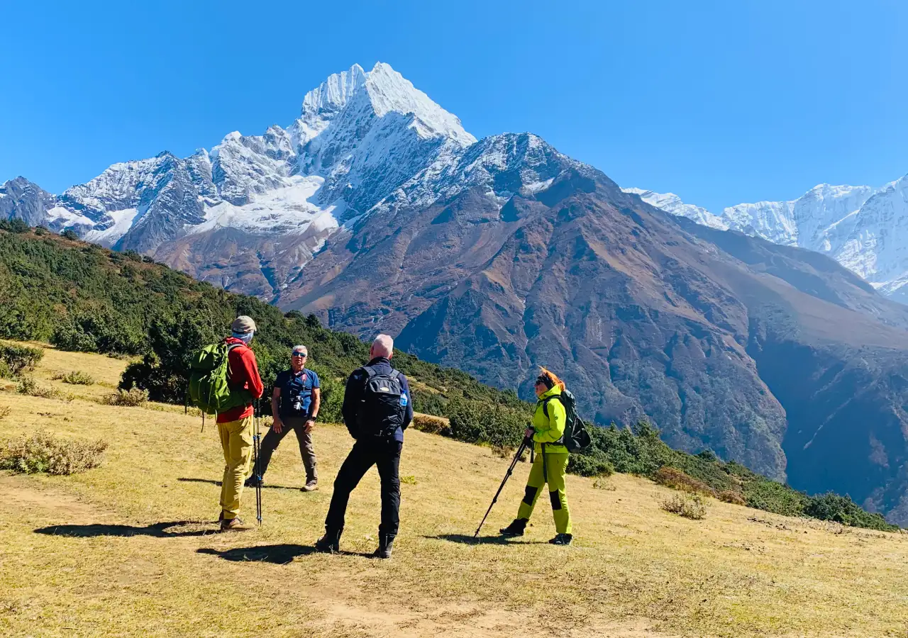 Trekkers walking the Everest trail with enjoying magnificent Thamserku Mountain in the background