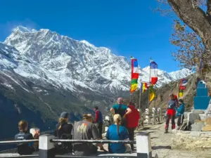 Annapurna Circuit Trek group at Ghyaru village with Annapurna mountain view, sputa and prayer flags