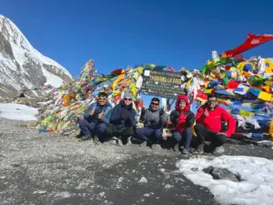 Explore Vision Nepal's Annapurna Circuit Trek group at Thorong La Pass top in Annapurna region Nepal