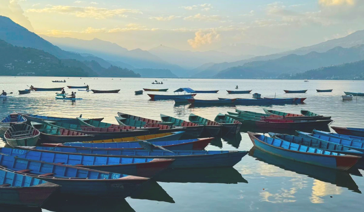 olorful boats on Phewa Lake surrounded by the scenic landscape of Pokhara Nepal