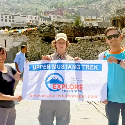 Trekkers with Explore Vision Nepal in the Upper Mustang landscape near a Buddhist monastery during Upper Mustang Trek with Yara Ghara trip
