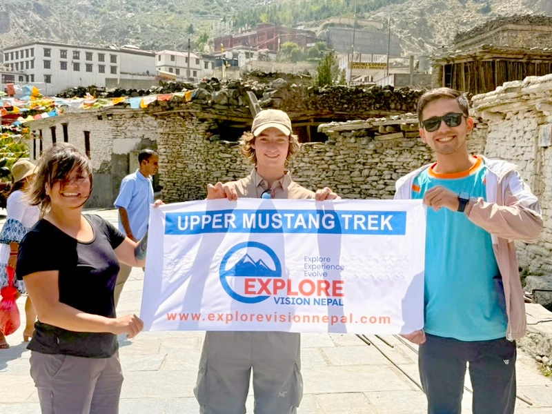 Trekkers with Explore Vision Nepal in the Upper Mustang landscape near a Buddhist monastery during Upper Mustang Trek with Yara Ghara trip