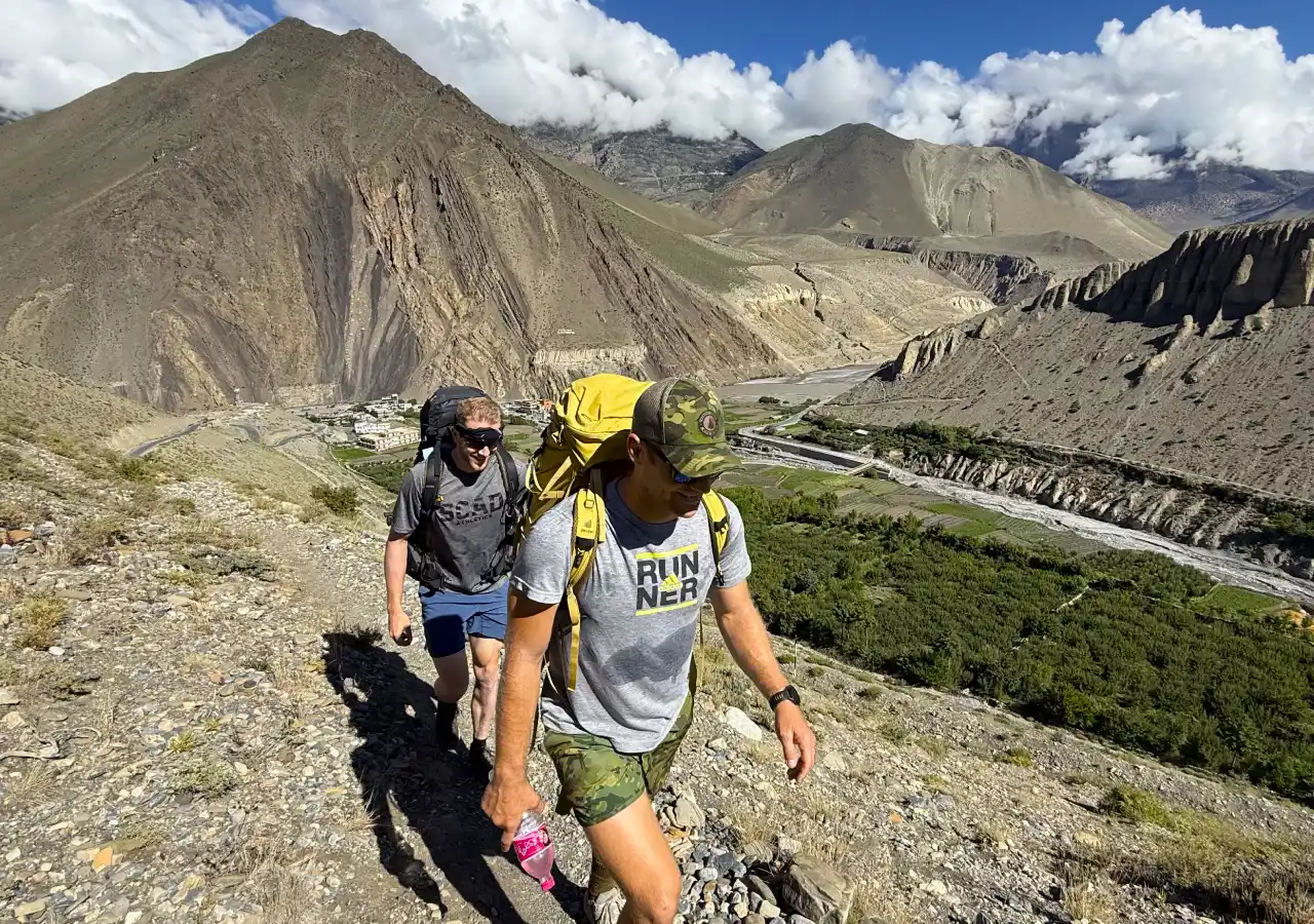 Trekkers hiking through the dramatic landscape of Upper Mustang Nepal on Upper Mustang Trek with Yara Ghara journey
