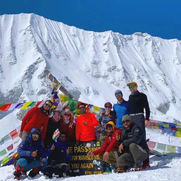 Trekkers celebrating at Larkya La Pass, 5,106m, on the Manaslu Base Camp Larke Pass Trek