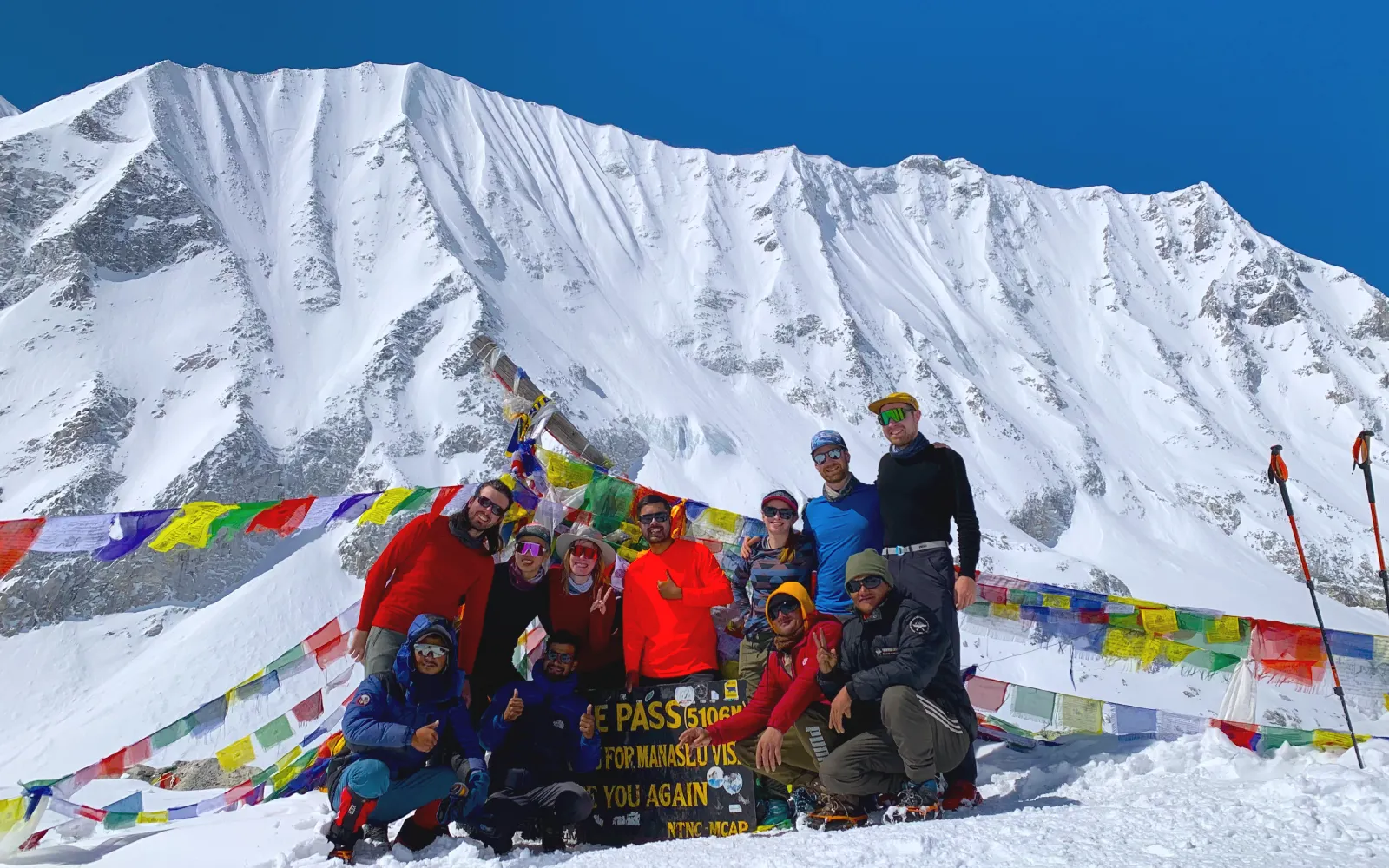 Trekkers celebrating at Larkya La Pass, 5,106m, on the Manaslu Base Camp Larke Pass Trek
