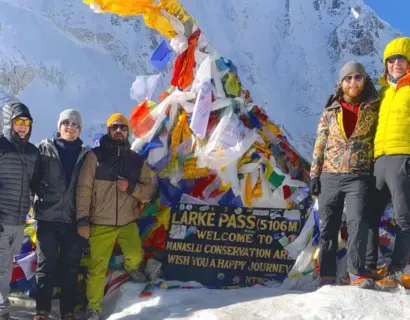 Explore Vision Nepal group at Larkya La Pass, 5,106m, with Himalayan prayer flags