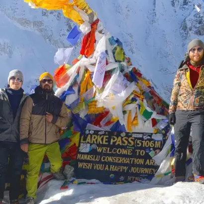 Explore Vision Nepal group at Larkya La Pass, 5,106m, with Himalayan prayer flags