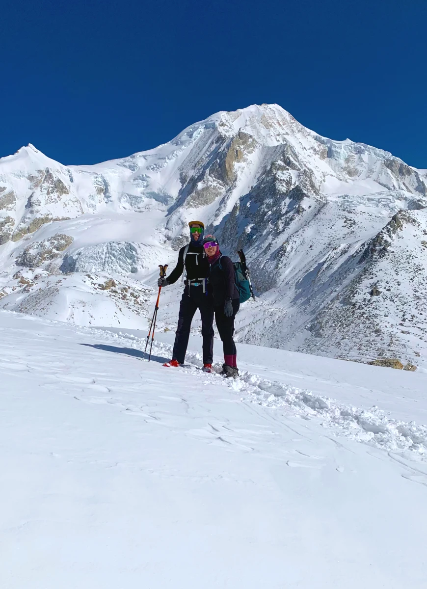 Trekkers hiking in the Manaslu region with clear mountain views, near Larkya La Pass, Nepal