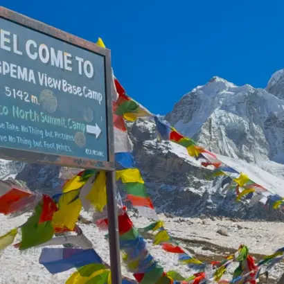 Mount Kanchenjunga and colorful prayer flags at Pangpema Base Camp Nepal during Kanchenjunga north base camp trek journey